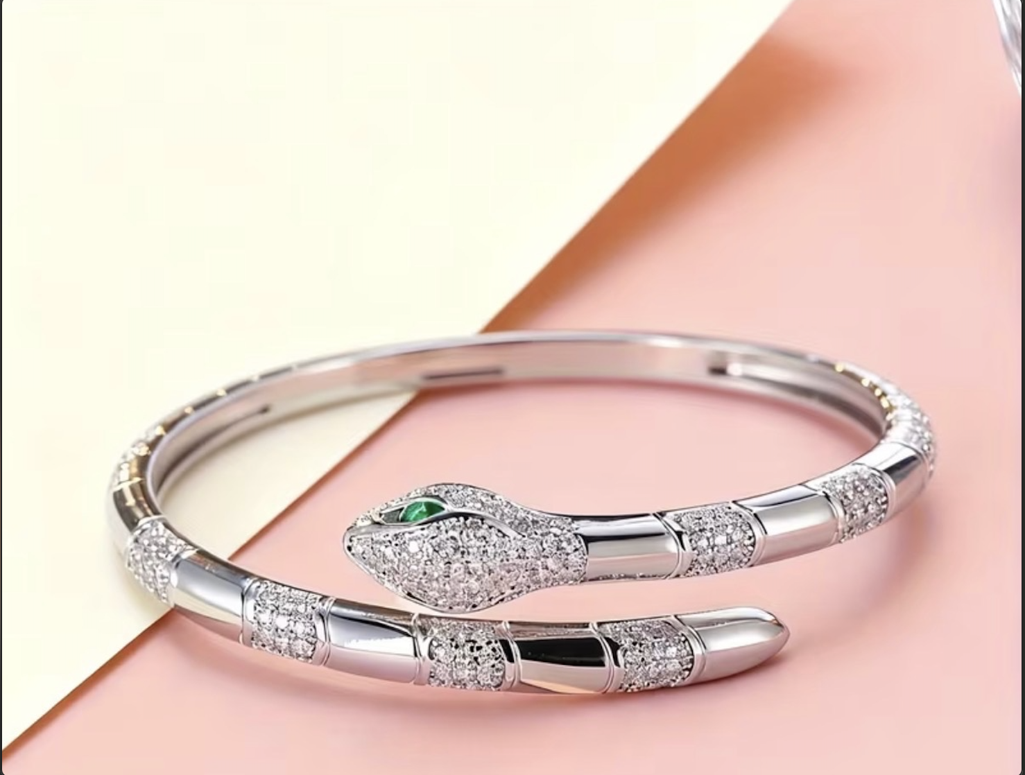Silver serpent bangle with crystal detailing and emerald eye
